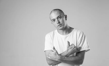 Black and white stylish modern epic portrait of bboy in a white t-shirt on a white background. Breakdance and hiphop dancer. Mysterious and cool.の写真素材