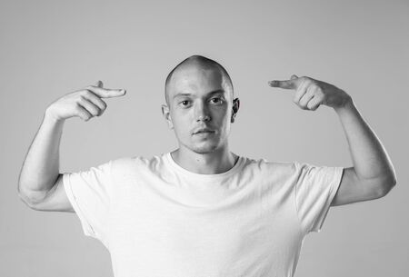 Black and white stylish modern epic portrait of bboy in a white t-shirt on a white background. Breakdance and hiphop dancer. Mysterious and cool.の写真素材