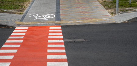 Cycling path with a symbol of bike on a ground through avtomobile road. Bike path in a modern city.