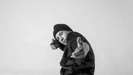 Black and white stylish modern epic portrait of bboy on a white background. Breakdance and hiphop...