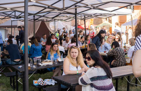 UKRAINE, LUTSK - June 20, 2019: People eating their food on a food fest outdoorのeditorial素材
