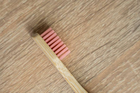 Eco-friendly bamboo toothbrush on a table. Zero-waste. Biodegradable toothbrush.の写真素材