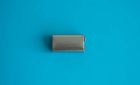 High voltage battery on a blue background. Silver Volt battery. 9V Advanced Lithium Batteries.の写真素材