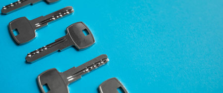 Door key lies on blue background. Set of keys. Bunch of keys. House key. New house concept. Rental...