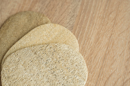 Natural loofah kitchen dish washing sponges. Eco friendly dishwashing sponge on a table, top view. Biodegradable dishwashing scrub pad.の写真素材