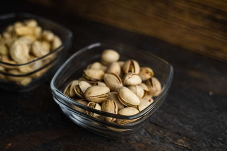 Almond, cachew and walnut in a small plates which standing on a black table. Nuts is a healthy vegetarian protein and nutritious food.の写真素材
