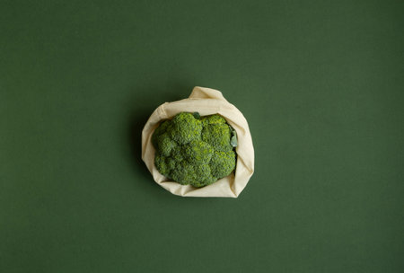 Broccoli in a reusable cotton mesh shopping bag. Zero waste concept. Eco-friendly lifestyle. Zero waste, healthy, vegan and clean eating concept. Plastic free items. Reuse, reduce, recycle, refuse.の写真素材