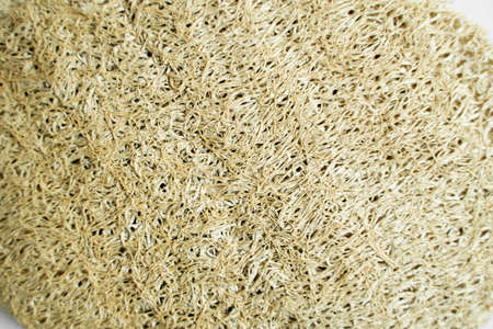 Natural loofah kitchen dish washing sponges. Eco friendly dishwashing sponge on a gray surface, top view. Biodegradable dishwashing scrub pad.の写真素材