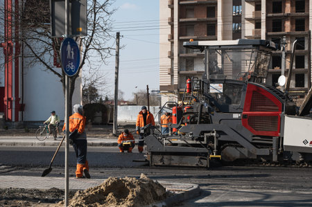 KYIV, UKRAINE - September 10, 2020: Industrial asphalt paver machine laying fresh asphalt on road...