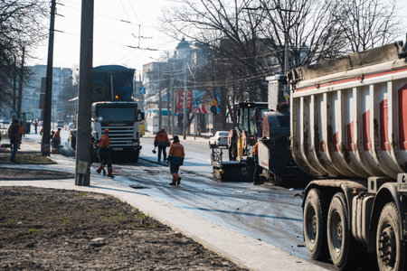 KYIV, UKRAINE - September 10, 2020: Industrial asphalt paver machine laying fresh asphalt on road...