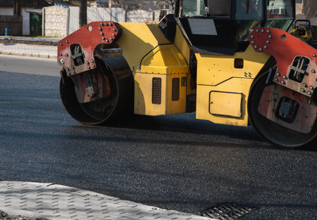 Asphalt road roller with heavy vibration roller compactor press new hot asphalt on the roadway on a...