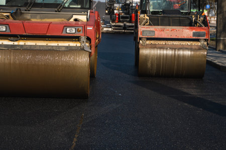 Asphalt road roller with heavy vibration roller compactor press new hot asphalt on the roadway on a...