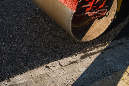Asphalt road roller with heavy vibration roller compactor press new hot asphalt on the roadway on a...