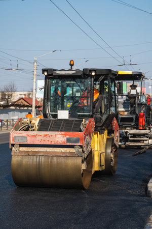 Asphalt road roller with heavy vibration roller compactor press new hot asphalt on the roadway on a...