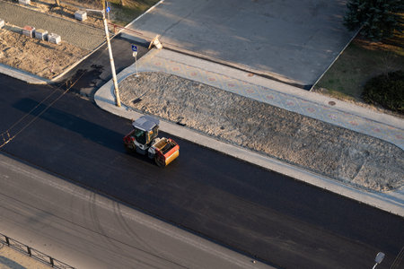 Asphalt road roller with heavy vibration roller compactor press new hot asphalt on the roadway on a...