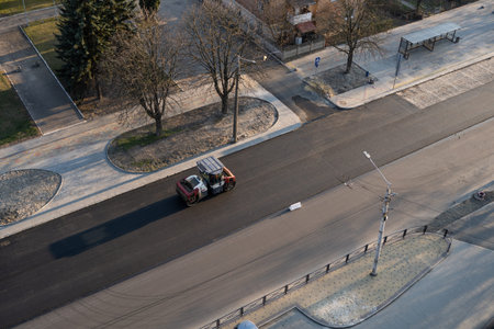Asphalt road roller with heavy vibration roller compactor press new hot asphalt on the roadway on a...