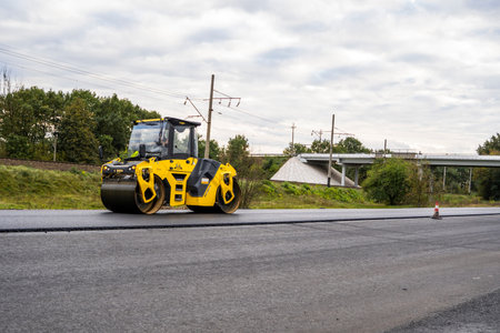 KYIV, UKRAINE - September 25, 2020: Heavy yellow asphalt road roller with heavy vibration roller...