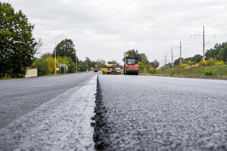 Asphalt road roller with heavy vibration roller compactor press new hot asphalt on the roadway on a...