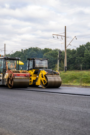 KYIV, UKRAINE - September 25, 2020: Two heavy asphalt road roller with heavy vibration roller...