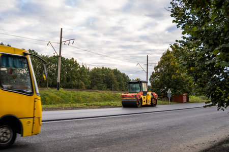 KYIV, UKRAINE - September 25, 2020: Heavy yellow asphalt road roller with heavy vibration roller...