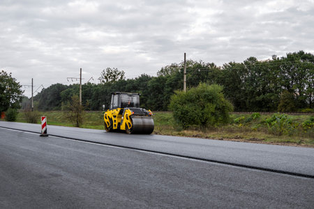 KYIV, UKRAINE - September 25, 2020: Heavy yellow asphalt road roller with heavy vibration roller...