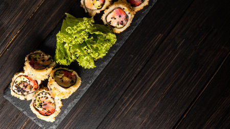 Custom sushi roll in tempura with nori, fresh salmon, tuna, avocado, masago caviar, drizzled with...