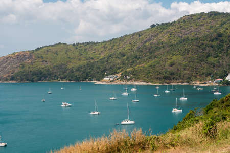 PHUKET, THAILAND - MAY 15, 2020: Sailing yachts and catamarans are parked at the harbor at Nai Harn Bay Phuket island.のeditorial素材