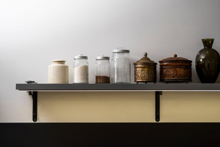 Modern kitchen shelves with various food ingredients on white background.