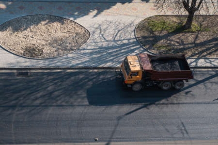 Truck with a breakstone on a road in the city during road construction work.の写真素材