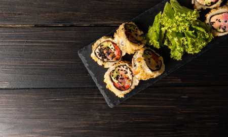 Custom sushi roll in tempura with nori, fresh salmon, tuna, avocado, masago caviar, drizzled with...