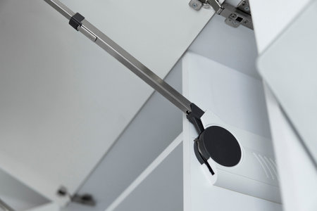 Kitchen cabinet with open fronts. Lift system for bifold fronts for direct access in kitchen cabinets.Innovative lifting mechanism for kitchen doors. Kitchen design.の写真素材