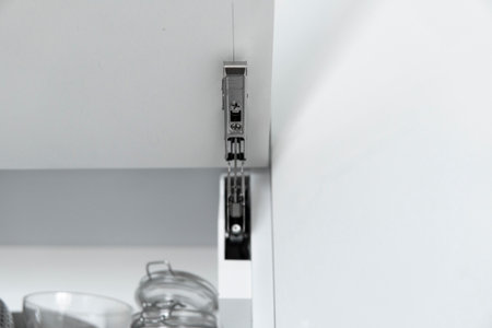 Kitchen cabinet with open fronts. Lift system for bifold fronts for direct access in kitchen cabinets.Innovative lifting mechanism for kitchen doors. Kitchen design.の写真素材