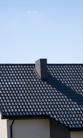 Brown corrugated metal profile roof installed on a modern house. The roof of corrugated sheet. Roofing of metal profile wavy shape. Modern roof made of metal. Metal roofing.の写真素材