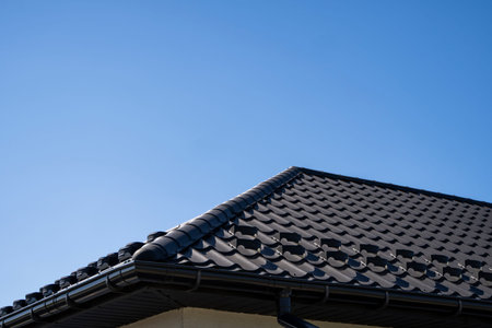 Brown corrugated metal profile roof installed on a modern house. The roof of corrugated sheet....
