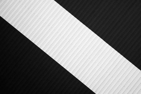 Black and white corrugated iron sheet used as a facade of a warehouse or factory. Texture of a seamless corrugated zinc sheet metal aluminum facade. Architecture. Metal texture.の写真素材