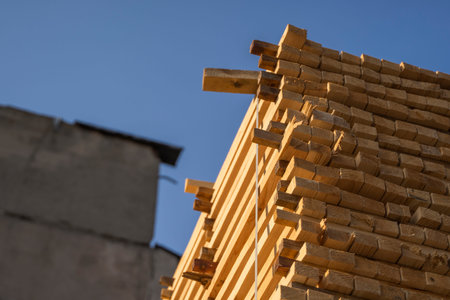 Storage of piles of wooden boards on the sawmill. Boards are stacked in a carpentry shop. Sawing...