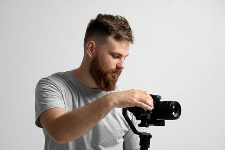 Videography, filmmaking and creativity concept. Portraite of videographer with a camera and gimbal....