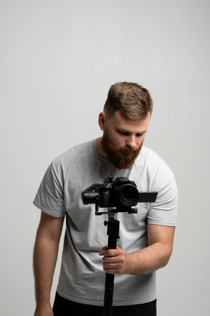 Videographer with a dslr mirrorless camera which set on 3-axis gimbal. Professional video equipment....