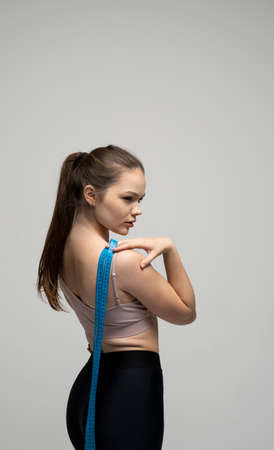 Weight loss and diet concepts. Sporty slim brunette women in sport outfit after fitness trainings.の写真素材