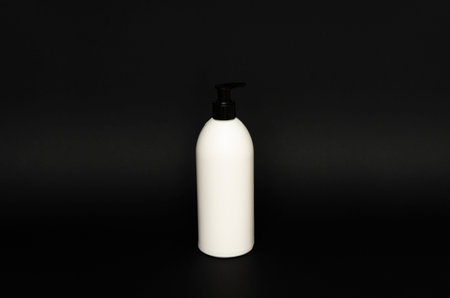 White plastic bottle used for shampoo or soap on black background.. Mock up template for design.の写真素材