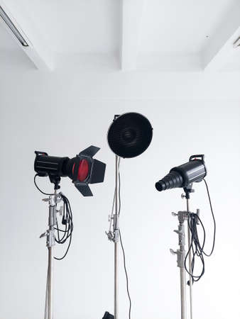 Professional lighting equipment, flashes, c-stands on a cyclorama in modern photo studio. Octabox, stripbox, softbox, buety plate and other stuff for photography.の写真素材