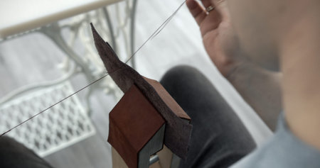 Sewing a brown leather wallet. Leather work. Sewing products by hand. Manufacture of leather goods.