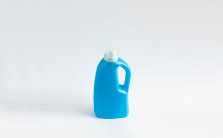 Blue plastic bottle with a grey cap isolated on white background for liquid detergent laundry or...