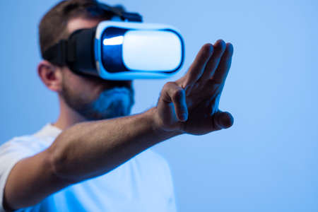 European mans in VR-glasses in neon. Concept of modern gadgets and technologies. VR, AR, MR, XR- Future technology.の写真素材