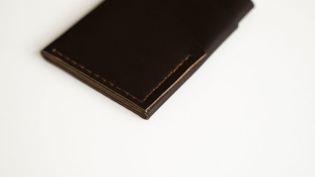 Brown empty mens business handmade leather card holder with isolated on white background. Selective...
