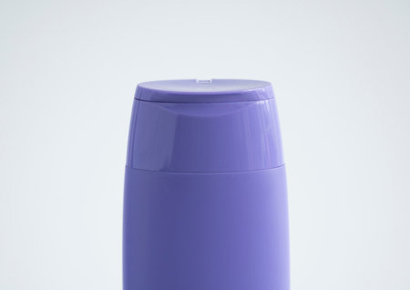 Violet plastic bottle of body care and beauty products. Studio photography of plastic bottle for shampoo, shower gel, creme isolated on white background.の写真素材