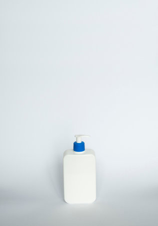 White unbranded bottle with a black dispenser isolated on white background. cosmetic packaging mockup with copy space. Bottle for a shower, gel, soap.の写真素材