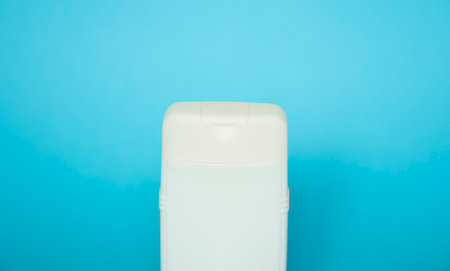 White square bottle for liquid soap, shampoo, gel on blue background.の写真素材