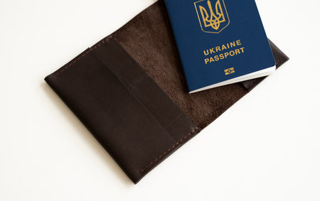 Ukrainian passport with a leather cover on a white background, selective focus. Inscription in Ukrainian Ukraine Passport.の写真素材