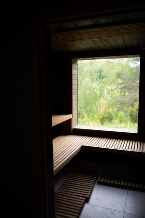 Small home wooden sauna, spa room. Relax in a hot sauna. Inside of empty Finnish sauna room. Modern interior of wooden spa cabin with dry steam.の写真素材
